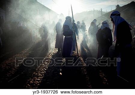 Penitents walk in a cloud of incense at the Jesus Nazareno de la Merced procession during Easter Holy Week procession in Antigua Guatemala, Guatemala, March 29, 2013. View Large Photo Image Stock Photograph - Penitents walk in a cloud of incense at the Jesus Nazareno de la Merced procession during Easter Holy Week procession in Antigua Guatemala, Guatemala, March 29, 2013.. Fotosearch