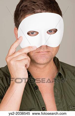 Pensive and serious man hiding behind white mask. View Large Photo Image Stock Photography - Pensive and serious man hiding behind white mask.. Fotosearch