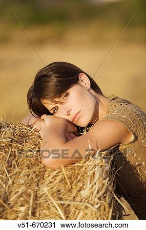 Stock Image - Pensive woman in the countryside. Fotosearch