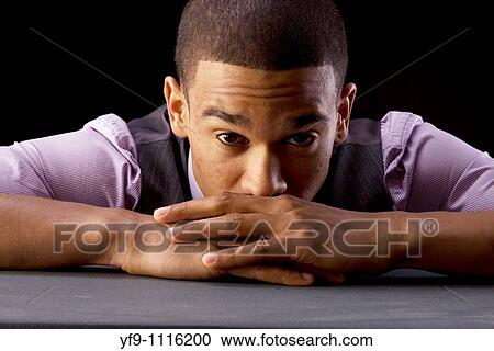 Stock Image - Pensive young businessman.. Fotosearch