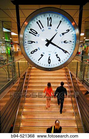 Stock Photo - People and clock in the metro station of Pla? a Catalunya, Barcelona. Catalonia, Spain. Fotosearch