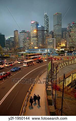 people and traffic pass through Central Hong Kong construction zone at dusk. View Large Photo Image Picture - people and traffic pass through Central Hong Kong construction zone at dusk.. Fotosearch