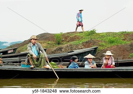 Stock Photo - People arriving at Inle lake to sell goods. Fotosearch