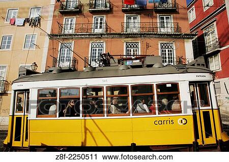 Stock Image - People at streetcar No 28 in Alfama, Lisbon.. Fotosearch