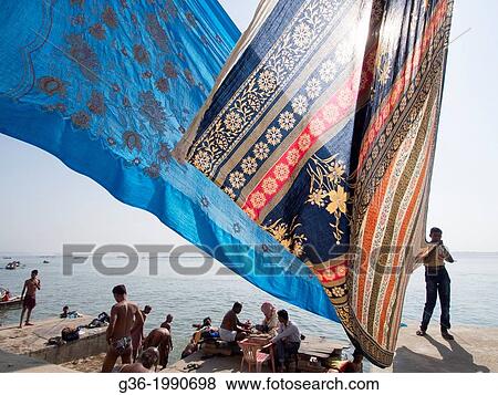 People bathing and drying clothes at river. View Large Photo Image Stock Photo - People bathing and drying clothes at river.. Fotosearch