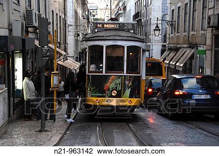 Stock Image - People boarding the popular tram 28 on the Rua da Concei? ao. Baixa, Lisbon, Portugal.. Fotosearch