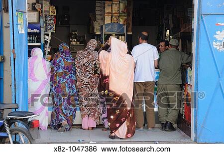 People buying in a shop in Dakhla, Morocco View Large Photo Image Stock Photograph - People buying in a shop in Dakhla, Morocco. Fotosearch