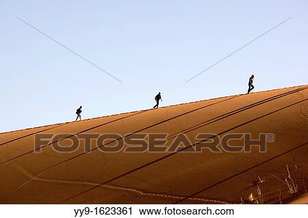 People Climbing Dunes - Sossusvlei National Park - Namib-Naukluft National Park, Namibia, Africa View Large Photo Image Stock Image - People Climbing Dunes - Sossusvlei National Park - Namib-Naukluft National Park, Namibia, Africa. Fotosearch