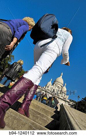 Stock Image - People climbing stairs in front of the Basilica Sacr? -Coeur. Montmartre. Paris, France.. Fotosearch