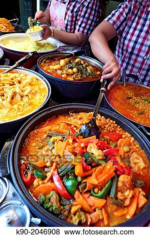 People cooking Indian Food, Food stall in Camden Town, London, England, Great Britain, Europe View Large Photo Image Stock Photo - People cooking Indian Food, Food stall in Camden Town, London, England, Great Britain, Europe. Fotosearch