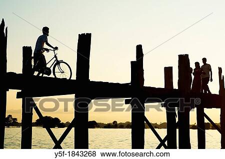 People crossing the U Bein bridge by dusk View Large Photo Image Stock Photo - People crossing the U Bein bridge by dusk. Fotosearch