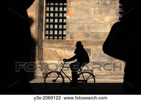 People cycling in the street next Dam Square downtown Amsterdam View Large Photo Image Stock Image - People cycling in the street next Dam Square downtown Amsterdam. Fotosearch