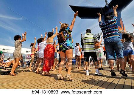 People dancing on the deck of a cruise ship View Large Photo Image Stock Image - People dancing on the deck of a cruise ship. Fotosearch