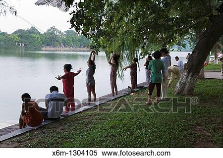 People doing exercise by Hoan Kiem lake. Hanoi, Vietnam. View Large Photo Image Stock Photography - People doing exercise by Hoan Kiem lake. Hanoi, Vietnam.. Fotosearch