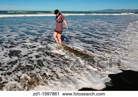 People enjoy the sea and sand at a beach in Christchurch, New Zealand. View Large Photo Image Stock Image - People enjoy the sea and sand at a beach in Christchurch, New Zealand.. Fotosearch
