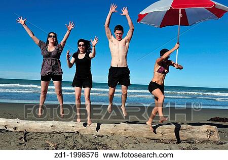 People enjoy the sea and sand at a beach in Christchurch, New Zealand. View Large Photo Image Stock Photograph - People enjoy the sea and sand at a beach in Christchurch, New Zealand.. Fotosearch
