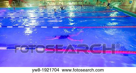 Picture - People enjoying a winter swim during the Winter lights Festival, Reykjavik, Iceland. Fotosearch