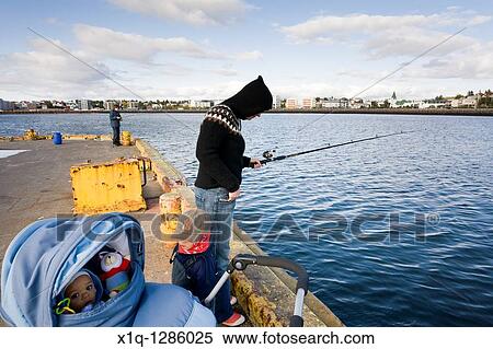 Stock Photography - People fishing by the harbour, Hafnarfjordur, Iceland. Fotosearch