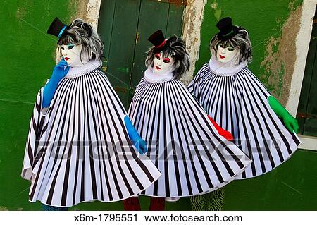 Stock Image - People in mask disguise in carnival Burano island Venice, Italy. Fotosearch