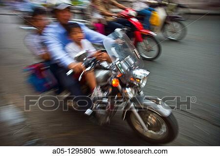People in motorbike. Ho Chi Minh City (formerly Saigon). South Vietnam. View Large Photo Image Stock Photography - People in motorbike. Ho Chi Minh City (formerly Saigon). South Vietnam.. Fotosearch