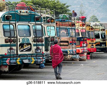 People in the bus station where former American school buses now serve as Guatemala's local and long distance buses, some with old markings from their past lives in America, still intact contrast with local culture at the bus station in the city of Antig View Large Photo Image Stock Image - People in the bus station where former American school buses now serve as Guatemala's local and long distance buses, some with old markings from their past lives in America, still intact contrast with local culture at the bus station in the city of Antig. Fotosearch