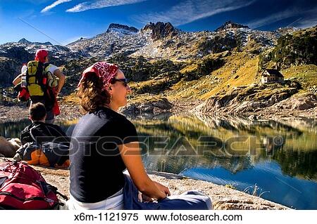 Stock Photography - people near the Bigger Lake of Colomer and Colomer I mountain hut Colomers glaciar cirque Aran Valley Pyrenees mountain range Lerida province Catalonia, Spain, Europe. Fotosearch