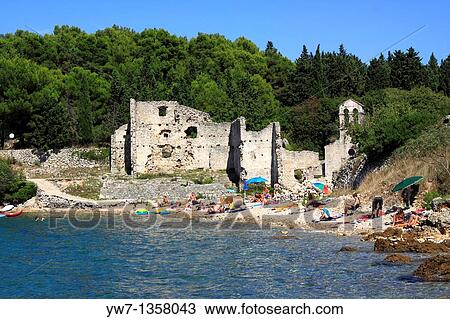 Stock Image - People on a beach at Bijar Bay in Osor, Croatia. Fotosearch