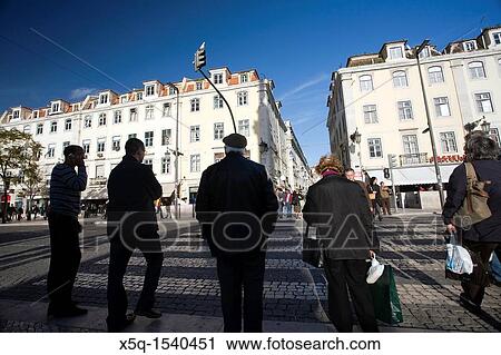 Stock Image - People on a zebra crossing, Rossio square, Lisbon. Fotosearch