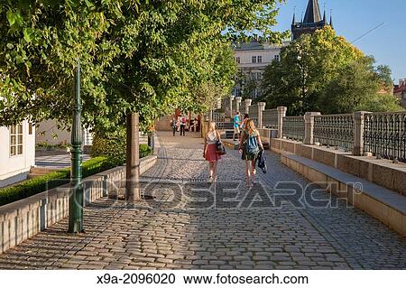 People on Footpath the Banks of the Vltava River with Charles Bridge, Prague; Czech Republic; Europe. View Large Photo Image Stock Image - People on Footpath the Banks of the Vltava River with Charles Bridge, Prague; Czech Republic; Europe.. Fotosearch