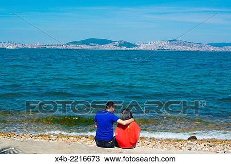 People on seaside with central Istanbul in background, Kinaliada, Adalar the Princes Islands, Sea of Marmara, Istanbul, Turkey, Asia Minor. View Large Photo Image Stock Image - People on seaside with central Istanbul in background, Kinaliada, Adalar the Princes Islands, Sea of Marmara, Istanbul, Turkey, Asia Minor.. Fotosearch