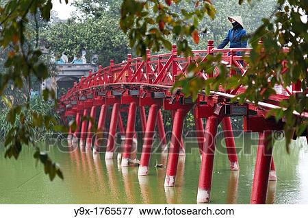 Stock Photo - People on the red bridge at the Hoan Kiem Lake in Vietnam. Fotosearch
