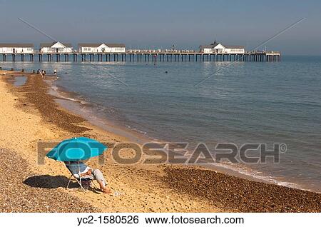 Stock Photograph - People on the seafront and beach in the summer in Southwold, Suffolk, England, Britain, Uk. Fotosearch