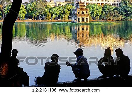 People on the shore of Hoan Kiem Lake, in the background is the Turtle Tower, Hanoi, Vietnam View Large Photo Image Stock Photograph - People on the shore of Hoan Kiem Lake, in the background is the Turtle Tower, Hanoi, Vietnam. Fotosearch