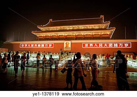 Stock Photo - People passing by a portrait of Mao Zedong on the Temple of Heavenly Peace at night, Tiananmen Square, Beijing, China. Fotosearch