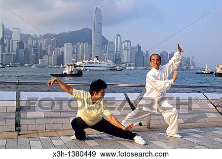 people practising Tai Chi Chuan along the Victoria Harbour waterfront in Tsim Sha Tsui, Kowloon Peninsula, Hong-Kong, People's Republic of China, Asia View Large Photo Image Stock Photo - people practising Tai Chi Chuan along the Victoria Harbour waterfront in Tsim Sha Tsui, Kowloon Peninsula, Hong-Kong, People's Republic of China, Asia. Fotosearch