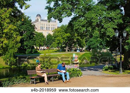 People reading Bastion Hill (Bastejkalns) park central Riga Latvia the Baltic States northern Europe. View Large Photo Image Stock Photo - People reading Bastion Hill (Bastejkalns) park central Riga Latvia the Baltic States northern Europe.. Fotosearch
