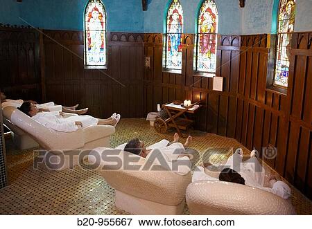 Stock Photo - People relaxing on hot stone seats, spa-relais. Lierganes hotel and spa, Cantabria, Spain. Fotosearch