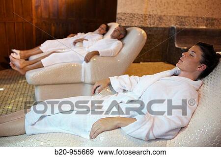 Stock Photo - People relaxing on hot stone seats, spa-relais. Lierganes hotel and spa, Cantabria, Spain. Fotosearch