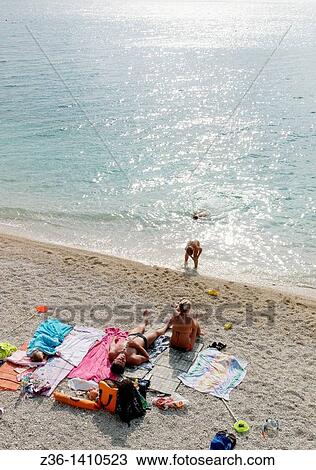 Stock Image - People resting at the Gradac beach, Croatia. Fotosearch