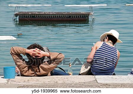people resting at the shore of Geneva Lake, Paquis beach, Geneva, Switzerland, Europe View Large Photo Image Stock Photography - people resting at the shore of Geneva Lake, Paquis beach, Geneva, Switzerland, Europe. Fotosearch