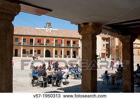 Stock Image - People sitting on terrace at the Main Square. Torrelaguna, Madrid province, Spain.. Fotosearch