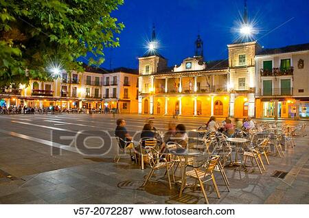 People sitting on terraces at Main Square, night view. El Burgo de Osma, Soria province, Castilla Leon, Spain. View Large Photo Image Stock Photo - People sitting on terraces at Main Square, night view. El Burgo de Osma, Soria province, Castilla Leon, Spain.. Fotosearch