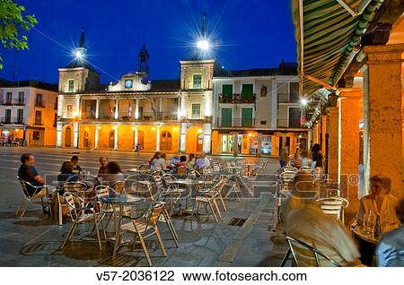 Stock Image - People sitting on terraces at the Main Square, night view. El Burgo de Osma, Soria province, Castilla Leon, Spain.. Fotosearch
