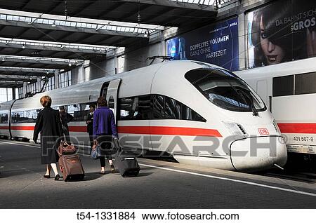 People walk at the Plattform to a ICE Train in Munich Station View Large Photo Image Picture - People walk at the Plattform to a ICE Train in Munich Station. Fotosearch