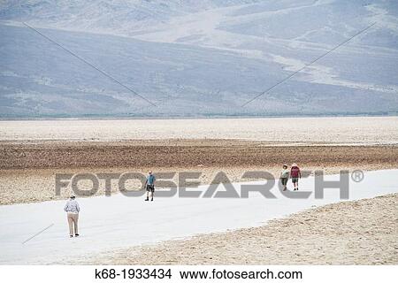 people walk in the desert at Badwater, Death Valley National Park, California, USA View Large Photo Image Picture - people walk in the desert at Badwater, Death Valley National Park, California, USA. Fotosearch