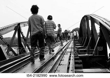People walking at the bridge on the River Kwai in Kanchanaburi View Large Photo Image Stock Image - People walking at the bridge on the River Kwai in Kanchanaburi. Fotosearch