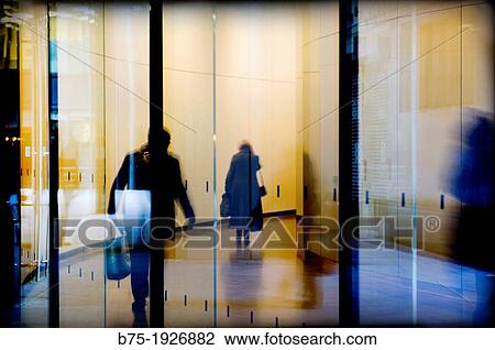 people walking down the hall of a building View Large Photo Image Stock Image - people walking down the hall of a building. Fotosearch