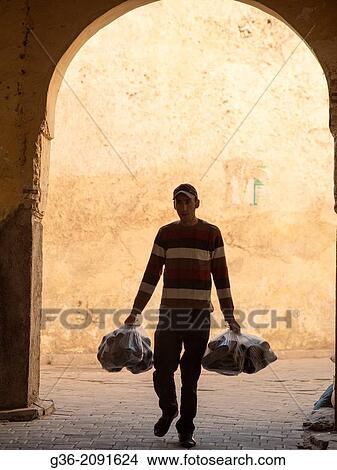 People walking down the street in the medina in Fez, Morrocco. View Large Photo Image Picture - People walking down the street in the medina in Fez, Morrocco.. Fotosearch