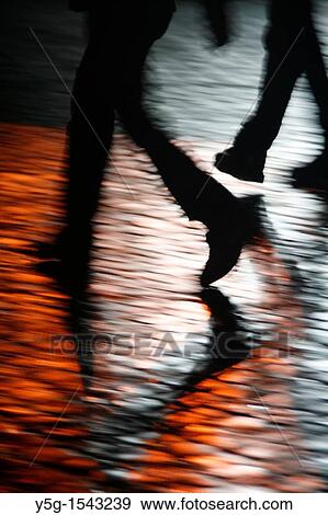 people walking in street at night View Large Photo Image Stock Photo - people walking in street at night. Fotosearch