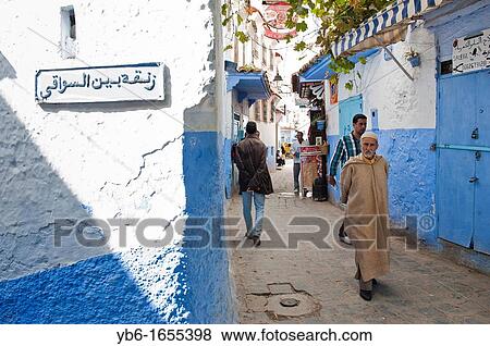people walking in the blue walled old medina of Chefchaouen, Morocco View Large Photo Image Stock Photo - people walking in the blue walled old medina of Chefchaouen, Morocco. Fotosearch
